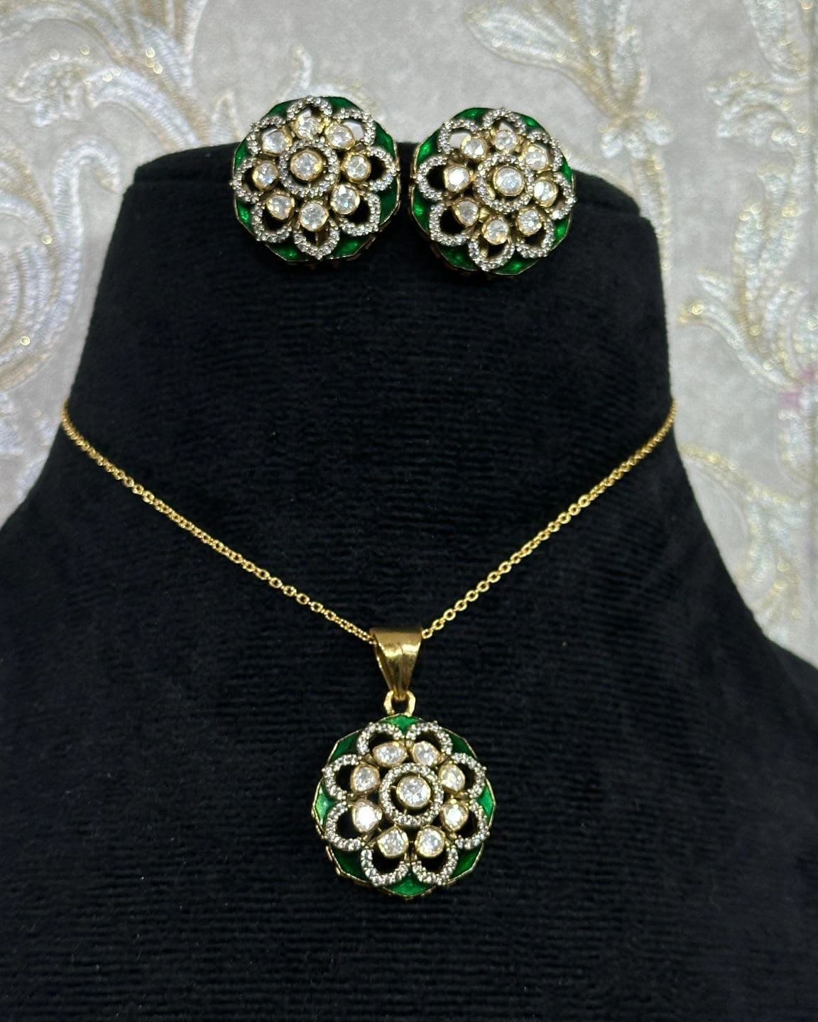 Emerald Meenakari — Green enamel edges a rosette of uncut stones, the colour turning with the light.
