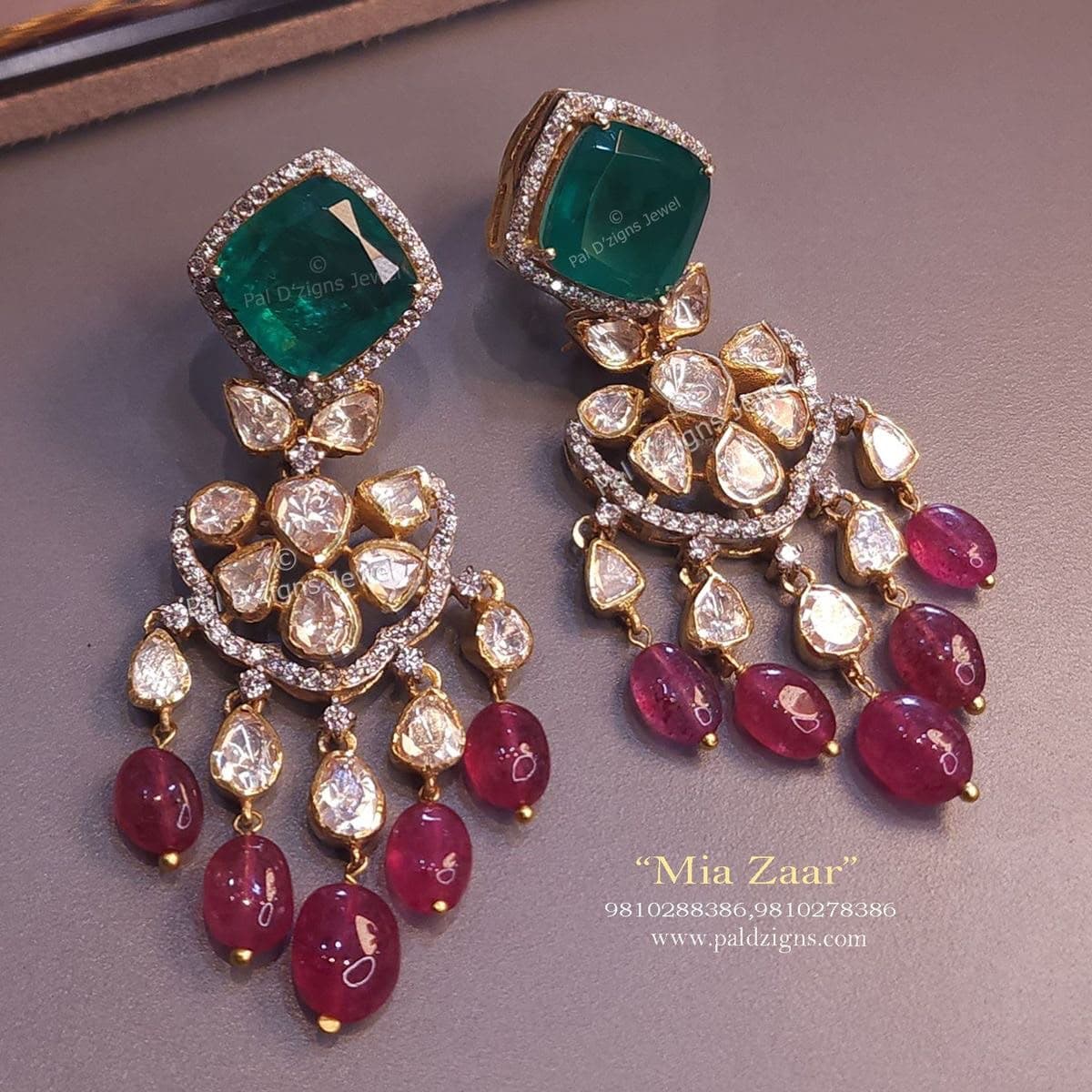 Emerald & Ruby Chandelier — A green cushion on top, a fan of uncut stones below, red beads along the fringe.