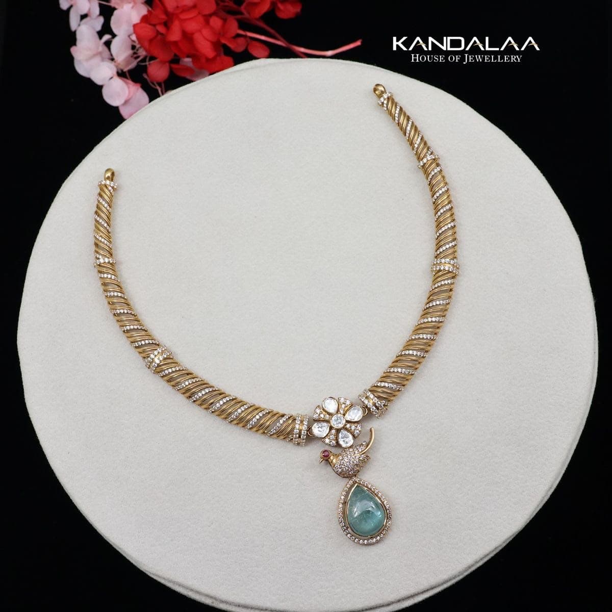 Peacock Collar — A ribbed collar opening to a flower, a small peacock, and a pale blue-green drop.