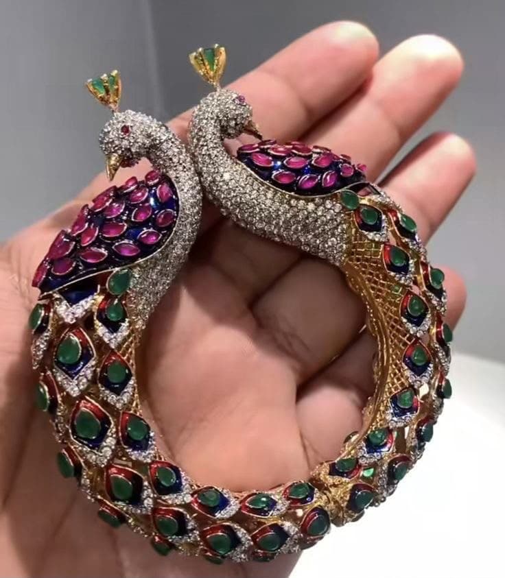 Peacock Heritage — Two peacocks meet along the curve of a single band — plumage laid in enamel, each feather eye set by hand.