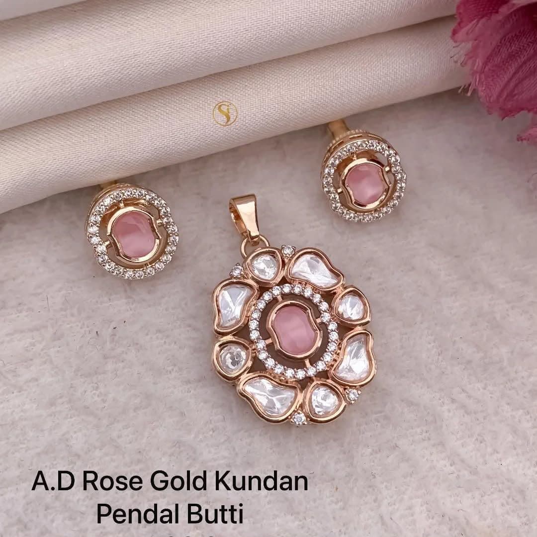 Rose Quartz — A pink centre circled by uncut stones, with studs to match.